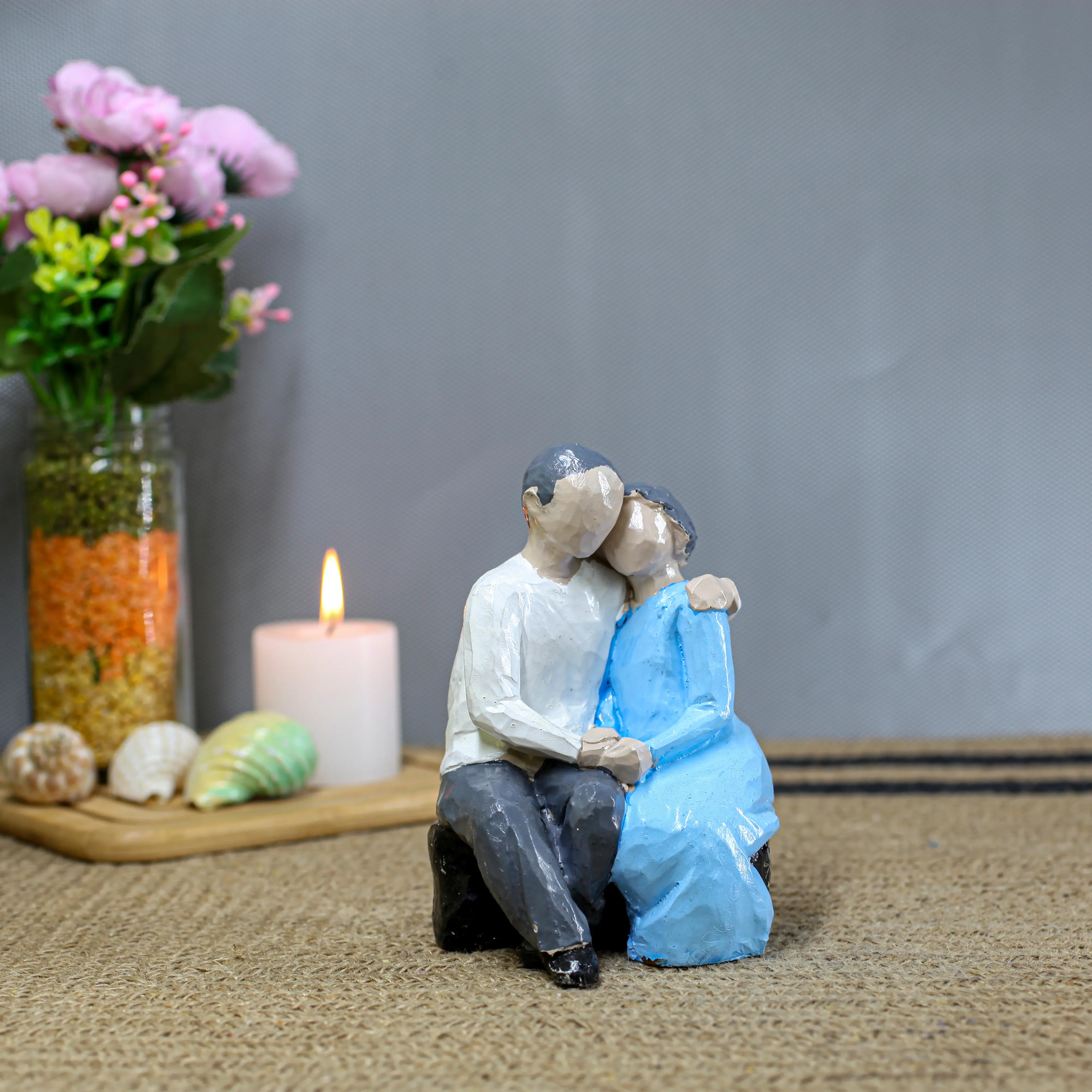 Small Couple Sitting on Stone